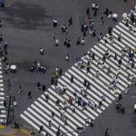 
              People move to all directions at pedestrian crossings Saturday, July 10, 2021, in Tokyo. The fourth state of emergency would go in effect on Monday and last through Aug. 22, despite the opening ceremony of Tokyo Olympics will be held in less than two weeks. (AP Photo/Kiichiro Sato)
            