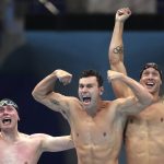 
              CORRECTS TO BECKER FROM BECK - United States men's 4x100m freestyle relay team Bowen Becker, Blake Pieroni, and Caeleb Dressel celebrate after winning the gold medal at the 2020 Summer Olympics, Monday, July 26, 2021, in Tokyo, Japan. (AP Photo/Matthias Schrader)
            
