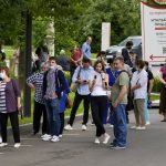 People wait in line to receive a coronavirus vaccine at a vaccination center, in VDNKh (The Exhibition of Achievements of National Economy) in Moscow, Russia, Friday, July 2, 2021. Russian health authorities on Thursday launched booster coronavirus vaccinations for those who had been immunized more than six months ago, as the country faces a surge in new infections and deaths. (AP Photo/Alexander Zemlianichenko)