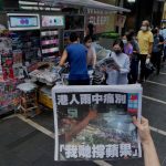 
              FILE - In this Thursday, June 24, 2021 file photo, a woman tries to take a picture of last issue of Apple Daily in front of a newspaper booth where people queue up to buy the newspaper at a downtown street in Hong Kong. The coronavirus pandemic has upended life around the globe, but it has hasn’t stopped the spread of authoritarianism and extremism. Some researchers believe it may even have accelerated it, but curbing individual freedoms and boosting the reach of the state. Since COVID-19 hit, Hungary has banned children from being told about homosexuality. China shut Hong Kong’s last pro-democracy newspaper. Brazil’s president has extolled dictatorship. Belarus has hijacked a passenger plane. A Cambodian human rights lawyer calls the pandemic “a dictator's dream opportunity.” But there are also resistance movements, as protesters from Hungary to Brazil take to the streets to defend democracy. (AP Photo/Vincent Yu, File)
            