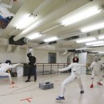 
              Fencing instructor Hiroshi Kato, second from left, lessons during practicing in Tokyo on June 21, 2021. Kato said he worries that he’ll lose even more business than he did during the coronavirus pandemic because he’s been ordered to move from the building where he works across from the main Olympics stadium from July 1 to Sep. 19, for unspecified security reasons. (AP Photo/Koji Sasahara)
            