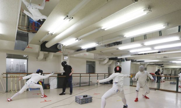 Fencing instructor Hiroshi Kato, second from left, lessons during practicing in Tokyo on June 21, 2...