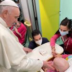 
              Pope Francis caresses a young oncological patient at the Agostino Gemelli Polyclinic in Rome, Tuesday, July 13, 2021, where he is hospitalized following intestine surgery. (Holy See Press Office via AP)
            