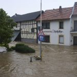 
              A street is flooded due to persistent storms, in Esch, Germany, Wednesday, July 14, 2021. Continuous rainfall has flooded numerous villages and cellars in Rhineland-Palatinate, southwestern Germany. (Thomas Frey/dpa via AP)
            