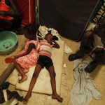 
              A boy lies on pieces of foam at a shelter for displaced Haitians, in Port-au-Prince, Haiti, Saturday, July 10, 2021, three days after Haitian President Jovenel Moise was assassinated in his home. The displaced Haitians were forced to flee their community where they had settled after the 2010 earthquake, after armed gangs set their homes on fire in late June. (AP Photo/Fernando Llano)
            