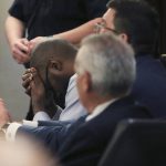 
              Defendant Otis McKane places his head in his hands after the jury came back with a guilty verdict in his capital murder trial for the 2016 shooting of San Antonio police detective Benjamin Marconi on Monday, July 26, 2021, in San Antonio. (Kin Man Hui/The San Antonio Express-News via AP)
            