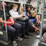 
              People sit on an Underground train, in London, Monday, July 19, 2021.  As of Monday, face masks are no longer legally required in England, and with social distancing rules shelved, there are no limits on the number of people attending theater performances or big events. (AP Photo/Alberto Pezzali)
            