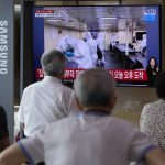 
              People watch a TV showing an image of South Korean service members wearing protective clothes disinfect inside the naval destroyer Munmu the Great during a news program at the Seoul Railway Station in Seoul, South Korea, Tuesday, July 20, 2021. South Korea's prime minister on Tuesday apologized for "failing to carefully take care of the health" of hundreds of sailors who contracted the coronavirus on a navy ship taking part in an anti-piracy mission off East Africa. (AP Photo/Ahn Young-joon)
            
