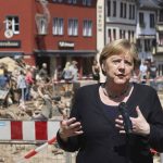 
              German Chancellor Angela Merkel speaks at a press conference in Muenstereifel, Germany, Tuesday, July 20, 2021. Merkel and North Rhine-Westphalia's Prime Minister Laschet visited Bad Muenstereifel, which was badly affected by the storm. (Oliver Berg/dpa via AP, Pool)
            
