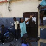 
              A woman orders her son to come down from a ladder at a shelter for displaced Haitians, in Port-au-Prince, Haiti, Saturday, July 10, 2021, three days after Haitian President Jovenel Moise was assassinated in his home. The displaced Haitians were forced to flee their community where they had settled after the 2010 earthquake, after armed gangs set their homes on fire in late June. (AP Photo/Fernando Llano)
            