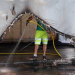 
              A municipality workers cleans the debris of a Covid-19 vaccination center in Urrugne, southwestern France, Monday, July 19, 2021, following an arson attack on Saturday evening. Two Covid-19 vaccination centers were ransacked in less than 48 hours in France, over the weekend. (AP Photo/Bob Edme)
            