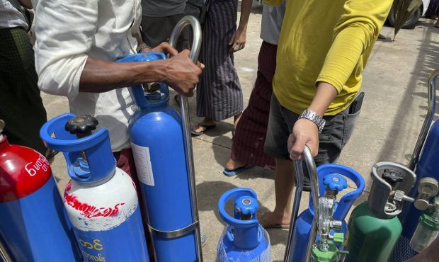 Oxygen tanks are lined up outside an oxygen refill station in Pazundaung township in Yangon, Myanma...
