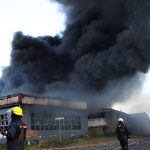 
              A factory burns on the outskirts of Durban, South Africa, Wednesday, July 14, 2021 in ongoing unrest. Rioting has continued which was sparked by the imprisonment last week of ex-President Jacob Zuma resulting in days of looting in two of the country's nine provinces. (AP Photo)
            