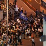 
              Protesters against the 2020 Summer Olympics gather outside the National Stadium, before the opening ceremony starts at the 2020 Summer Olympics, Friday, July 23, 2021, in Tokyo. (AP Photo/Shuji Kajiyama)
            