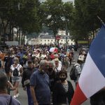 
              Protestors march waving French flags during a demonstration in Lyon, central France, Saturday, July 31, 2021. Demonstrators gathered in several cities in France on Saturday to protest against the COVID-19 pass, which grants vaccinated individuals greater ease of access to venues. (AP Photo/Laurent Cipriani)
            