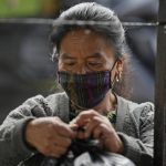 
              A vendor removes merchandise from her stall at the market, closed on the second day of a four-day lockdown decreed by local authorities to help curb the spread of COVID-19 in the Kaqchikel Indigenous town of San Martin Jilotepeque, Guatemala, Friday, July 9, 2021. On Thursday, Guatemala announced its highest number of infections since the pandemic began, with 3,000 infected in a single day. (AP Photo/Moises Castillo)
            