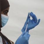 
              An NHS worker prepares a Covid vaccination jab at a pop-up vaccination centre during a four-day vaccine festival in Langdon Park, east London, Saturday July 31, 2021.  The authorities are implementing a program of short term pop-up vaccination sites in an attempt to prompt people to get the jab. (Kirsty O'Connor/PA via AP)
            