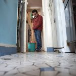 
              Joao Luiz Bulcao, 58, mops the kitchen floor on May 20, 2021, in the apartment in Montmartre, Paris, where he lives with his wife, Nathalie, and their two daughters. Bulcao, a Brazil-born photographer, traveled widely in Brazil, the United States and elsewhere during his career as a photographer but then found himself largely house-bound in Paris during the pandemic. Occasional payments of financial aid from the goverment helped the family make rent. With roots in both France and Brazil, Bulcao and his family feel fortunate to have weathered the pandemic in Paris. (AP Photo/Joao Luiz Bulcao).
            
