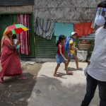 
              A health worker arrives in a residential neighborhood to collect swab samples from residents to test for COVID-19 during a door-to-door testing drive in Gauhati, India, Friday, July 9, 2021. (AP Photo/Anupam Nath)
            