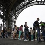 
              Visitor line up at the Eiffel Tower in Paris, Friday, July 16, 2021. The Eiffel Tower is reopening Friday for the first time in nine months, just as France faces new virus rules aimed at taming the fast-spreading delta variant. The "Iron Lady" was ordered shut in October as France battled its second surge of the virus. (AP Photo/Michel Euler)
            