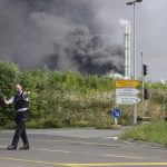 
              A police officer blocks an access road to the Chempark in Leverkusen, Germany, Tuesday, July 27, 2021 after an explosion in which the emergency services were in large-scale operation to tackle. (Oliver Berg/dpa via AP)
            