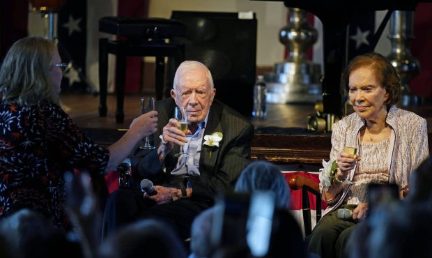 Amy Carter, left, rises her glass during a toast to her parents former President Jimmy Carter and f...