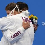 
              Gold medalist Chase Kalisz, left, of the United States, embraces teammate and silver medalist Jay Litherland, during the medal ceremony for the the men's 400-meter individual medley at the 2020 Summer Olympics, Sunday, July 25, 2021, in Tokyo, Japan. (AP Photo/Martin Meissner)
            
