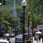 
              FILE -In this June 16 2021 file photo, people walk on one of the main streets in Ellenville, N.Y. in Ulster County. Though pretty, there are pockets of poverty. The county is working with the Center for Guaranteed Income Research at the University of Pennsylvania on a pilot program funded by private donations. One hundred households making less than $46,900 a year in May began receiving a $500 payment each month for a year. Recipients of the money can spend it as they wish, but will be asked to participate in periodic surveys about their physical health, mental health and employment status. (AP Photo/Seth Wenig File)
            