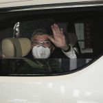 
              International Olympic Committee (IOC) President Thomas Bach waves from the vehicle to media upon his arrival an accommodation Thursday, July 8, 2021, in Tokyo. Bach arrived on Thursday, July 8, 2021, in Tokyo as Japan Prime Minister Yoshihde Suga was set to declare a state of emergency that is likely to result in a ban on fans from the Tokyo Olympics as coronavirus infections spread across the capital. (AP Photo/Eugene Hoshiko, Pool)
            