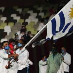 
              Deborah Rodriguez and Bruno Cetraro Berriolo, of Uruguay, carry their country's flag during the opening ceremony in the Olympic Stadium at the 2020 Summer Olympics, Friday, July 23, 2021, in Tokyo, Japan. (AP Photo/Natacha Pisarenko)
            