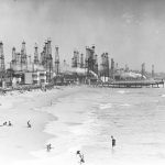 
              In this undated historical image provided by the University of Southern California library, people enjoy the beach in front of an oil field in Playa del Rey, Calif. There are 3.2 million abandoned oil and gas wells in the U.S., according to the Environmental Protection Agency. About a third were plugged with cement, which is considered the proper way to prevent harmful chemical leaks. But most, about 2.1 million by the EPA's count, haven't been plugged at all. (USC via AP)
            