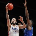 
              France's Evan Fournier (10) drives to the basket past the United States' Bam Adebayo, right, during a men's basketball preliminary round game at the 2020 Summer Olympics, Sunday, July 25, 2021, in Saitama, Japan. France won 83-76. (AP Photo/Charlie Neibergall)
            