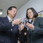 In this photo released by the Taiwan Presidential Office, Taiwan President Tsai Ing-wen, right, looks at samples with Medigen CEO Charles Chen during a visit to the company in Hsinchu in northern Taiwan on Feb. 20, 2020. Taiwan is planning to take a regulatory shortcut that would allow vaccines currently under development to be given out before the final stage of testing is finished. Supporters say the shortcut is necessary because Taiwan is in a real crunch, scrambling to get vaccines amid its worst outbreak of the pandemic. (Taiwan Presidential Office via AP)