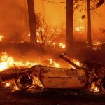 
              Flames consume vehicles as the Dixie Fire tears through the Indian Falls community in Plumas County, Calif., Saturday, July 24, 2021. The fire destroyed multiple residences in the area. (AP Photo/Noah Berger)
            