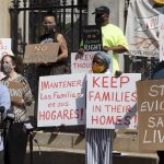 
              People from a coalition of housing justice groups hold signs protesting evictions during a news conference outside the Statehouse, Friday, July 30, 2021, in Boston. (AP Photo/Michael Dwyer)
            