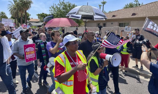 Demonstrators march toward the office of U.S. Sen. Kyrsten Sinema, D-Arizona, on Monday, July 26, 2...