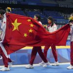 
              China's women's 4x200-meter freestyle relay team, of Yang Junxuan, Tang Muhan, Zhang Yifan and Li Bingjie carry their national flag after receiving their gold medals at the 2020 Summer Olympics, Thursday, July 29, 2021, in Tokyo, Japan. (AP Photo/Matthias Schrader)
            