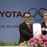
              FILE - In this March 13, 2015 file photo, Toyota President and CEO Akio Toyoda, left, and IOC President Thomas Bach pose with a signed document during a press conference in Tokyo as Toyota signed on as a worldwide Olympic sponsor in a landmark deal, becoming the first car company to join the IOC's top-tier marketing program. Toyota won't be airing any Olympic-themed advertisements on Japanese TV during the Tokyo Games despite being one of the IOC's top corporate sponsors. The unusual decision by the country's top automaker underlines how polarizing the Games have become in Japan as COVID-19 infections rise ahead of the July 23, 2021, opening ceremony.(AP Photo/Eugene Hoshiko, File)
            