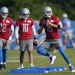 
              Detroit Lions quarterbacks Jared Goff, right, David Blough (10) and Tim Boyle (12) run through a drill at the Lions NFL football camp practice, Wednesday, July 28, 2021, in Allen Park, Mich. (AP Photo/Carlos Osorio)
            