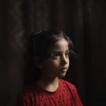 
              Elien al-Madhoun, 6, poses for a portrait at her grandfather's house, where she is living after her house was destroyed during an 11-day war, in Beit Lahia, northern Gaza Strip, Saturday, June 19, 2021. Elien was not yet born when her father lost his home in the 2014 Gaza War. Young as she is, she doesn't entirely understand life and death. But in May, she screamed out at the sounds of airstrikes and shelling in Bait Lahia in northern Gaza, says her father, Ahmed Rabah al-Madhoun. “When nine homes are completely destroyed next to one another and my daughter sees this, she can’t understand what happened,” he says. (AP Photo/Felipe Dana)
            