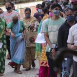 
              People wait to get inoculated against the coronavirus at a vaccination center in Mumbai, India, Sunday, July 4, 2021. (AP Photo/Rafiq Maqbool)
            