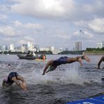
              Morgan Pearson of the United States, center, dives into the water for the start of the men's individual triathlon at the 2020 Summer Olympics, Monday, July 26, 2021, in Tokyo, Japan. (AP Photo/Jae C. Hong)
            