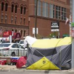 
              A tent put up by homeless individuals sits on a sidewalk Thursday, July 8, 2021, one block east of the Colorado Convention Center, the site of a major League Baseball promotion to mark the playing of the All Star Game in Denver. (AP Photo/David Zalubowski)
            