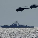
              Ukrainian helicopters fly over a Russian warship  during Sea Breeze 2021 maneuvers, in the Black Sea, Friday, July 9, 2021. Ukraine and NATO have conducted Black Sea drills involving dozens of warships in a two-week show of their strong defense ties and capability following a confrontation between Russia's military forces and a British destroyer off Crimea last month. (AP Photo/Efrem Lukatsky)
            