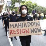 
              A protester holds placard during a demonstration demanding the prime minister step down near the Independence Square in Kuala Lumpur, Saturday, July 31, 2021. Hundreds of black-clad Malaysian youths have rallied in the city center, demanding Prime Minister Muhyiddin Yassin resign for mismanaging the coronavirus pandemic that has worsened. (AP Photo/FL Wong)
            