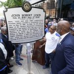 
              People look at a new historical marker remembering former Rep. John Lewis after it was unveiled Friday, July 16, 2021, in Nashville, Tenn. Earlier this year, Nashville's Metro Council renamed a large portion of Fifth Avenue to Rep. John Lewis Way. (AP Photo/Mark Humphrey)
            