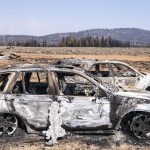 
              Two cars that were destroyed by the Bootleg Fire sit near damaged property Thursday, July 22, 2021, near Bly, Ore. (AP Photo/Nathan Howard)
            