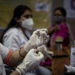 
              A health worker prepares to administer the Covishield vaccine to a woman at a government hospital in Noida, a suburb of New Delhi, India, Monday, July 12, 2021. (AP Photo/Altaf Qadri)
            