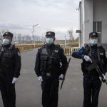 
              Police officers stand at the outer entrance of the Urumqi No. 3 Detention Center in Dabancheng in western China's Xinjiang Uyghur Autonomous Region on April 23, 2021. Urumqi No. 3, China's largest detention center, is twice the size of Vatican City and has room for at least 10,000 inmates. (AP Photo/Mark Schiefelbein)
            
