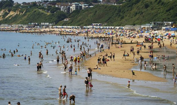 People enjoy the weather on Bournemouth beach in Dorset, England, Monday July 19, 2021. (Steve Pars...